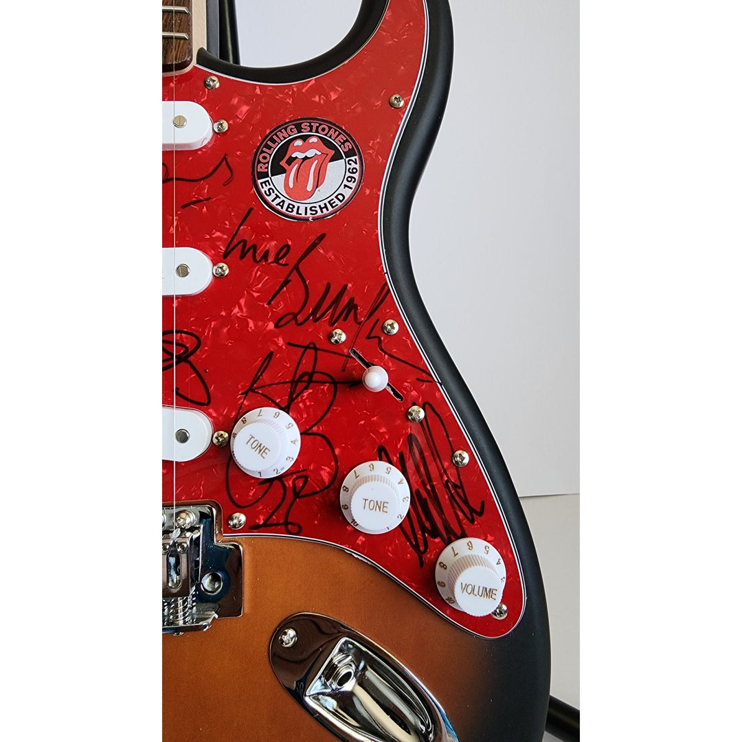 Mick Jagger, Keith Richards, Bill Wyman, Ronnie Wood, Mick Taylor, Charlie Watts Fender Stratocaster electric guitar signed with proof