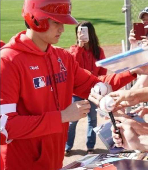 Shohei Ohtani signing baseballs