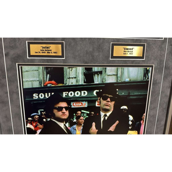 The Blues Brothers Dan Akroyd & John Belushi autograph book page signed with proof & museum quality frame with plexi 25x35.