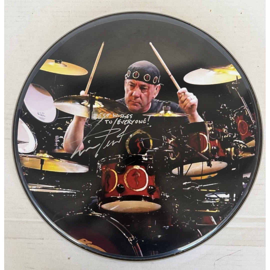 Neil Peart Rushs' iconic drummer drumhead signed with proof.