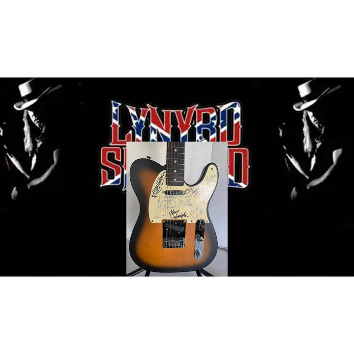 Sunburst electric guitar on stand, with bold "Lynyrd Skynyrd" text and silhouettes in background.