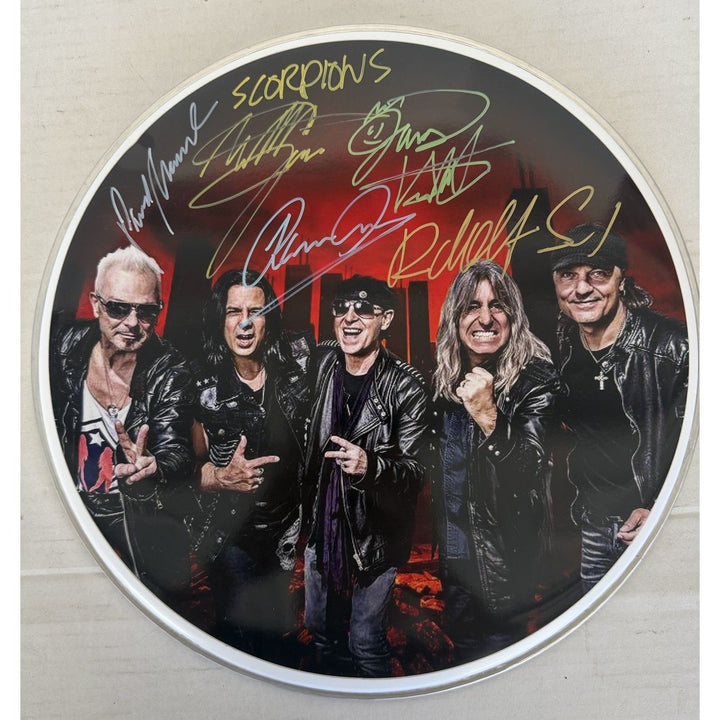 Scorpions Klaus Maine, Rudolf Schenker, Pawel Maciwoda drumhead signed with proof.