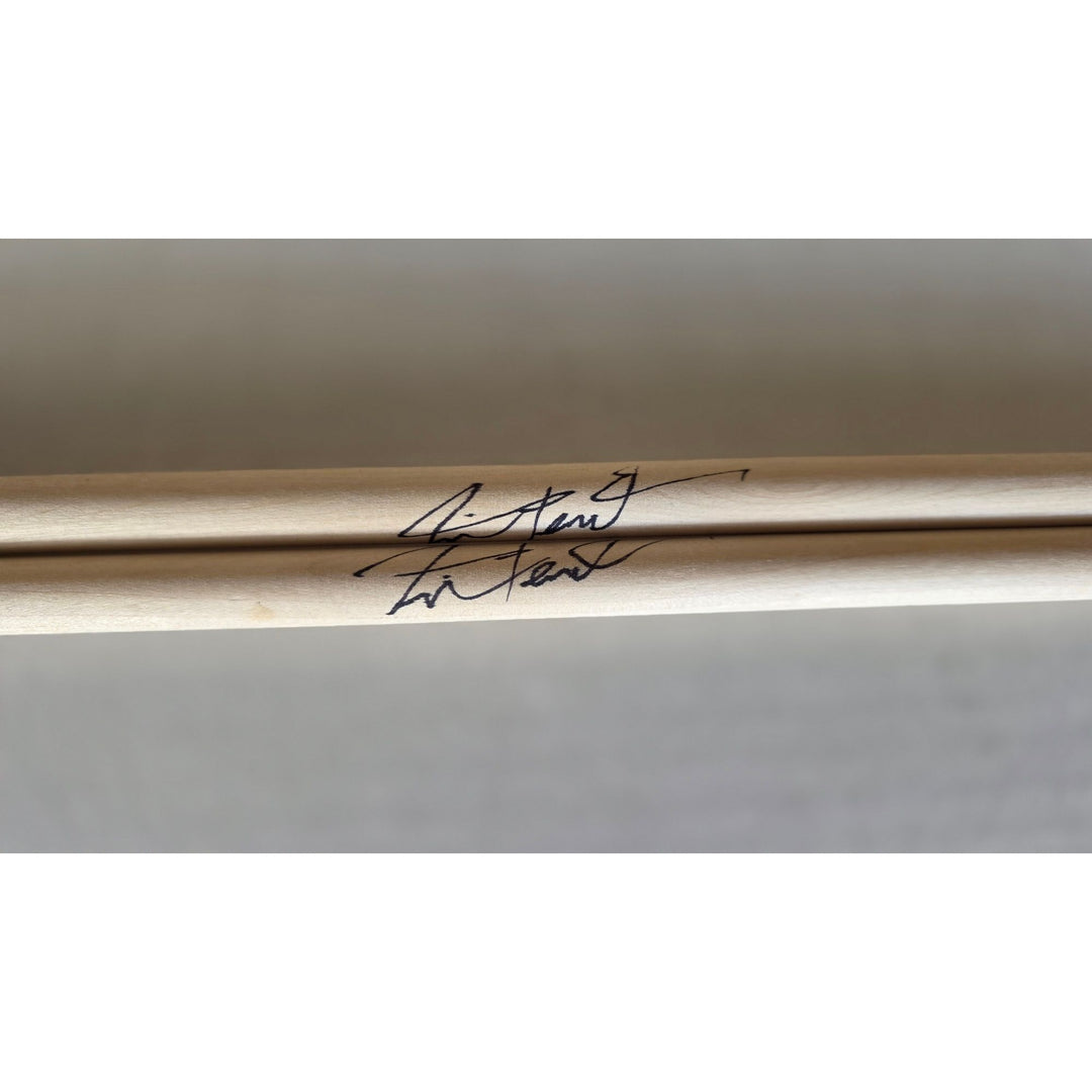 Neil Peart Rush pair of drumsticks signed with proof.