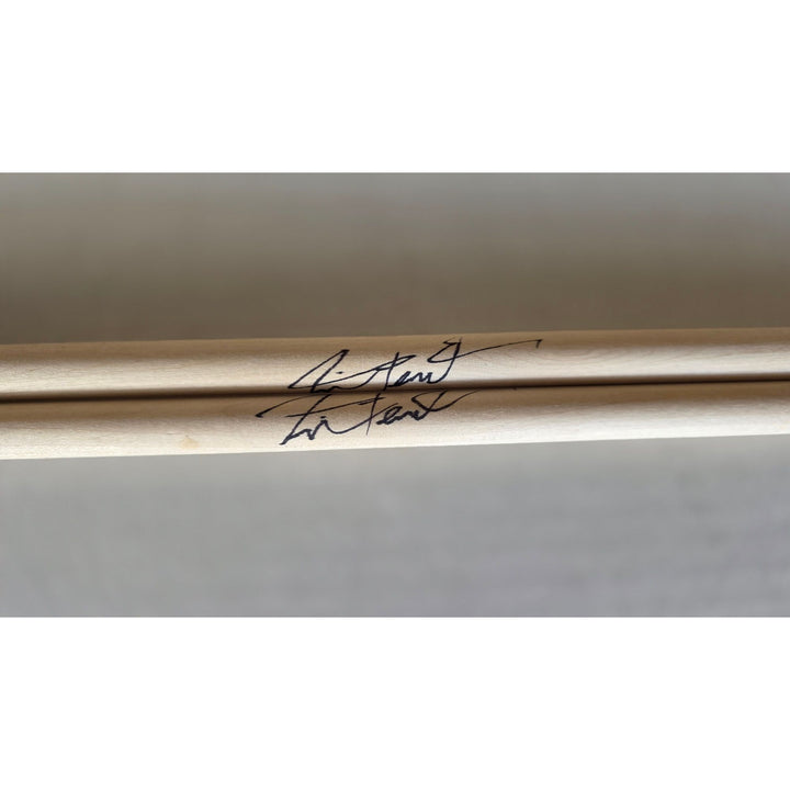 Neil Peart Rush pair of drumsticks signed with proof.