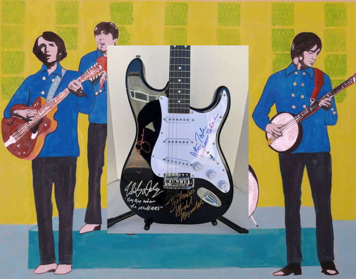The Monkees Michael Nesmith, Peter Tork, Micky Dolenz, and Davey Jones full size Stratocaster electric guitar signed with proof