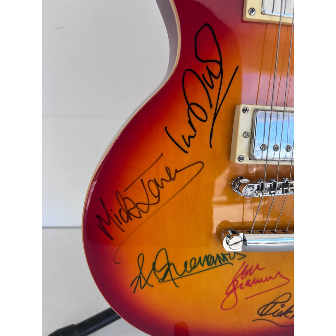 Lou Gramm, Dennis Elliott, Al Greenwood, Ian McDonald, Mick Jones, and Rick Wills vintage Les Paul full size electric guitar signed.