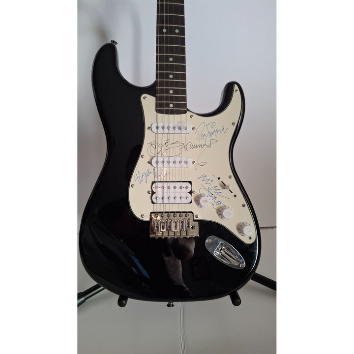 Mick Jones, Joe Strummer, Topper Headon, & Paul Simonon, The Clash Fender Stratocaster electric guitar signed with proof