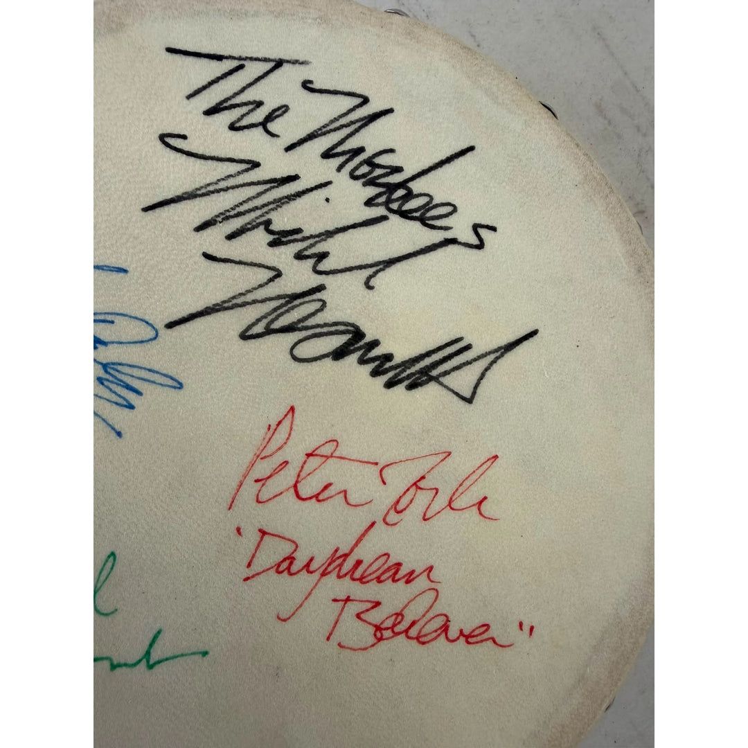 The Monkees signed with inscriptions Michael Nesmith, Davey Jones Mickey Dolenz Peter York Tambourine 8" signed with proof.
