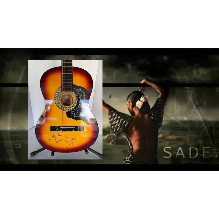 A sunburst acoustic guitar with a signature, set against a backdrop of a dancer and the word "SADE."