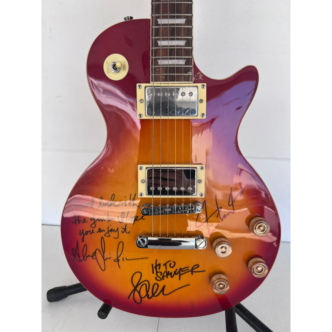 Rush one of a kind Geddy Lee Neil Peart Alex Lifeson vintage cherry les pail full size electric guitar signed and inscribed with proof.
