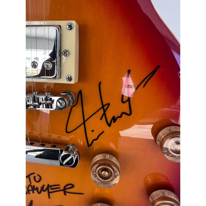 Rush one of a kind Geddy Lee Neil Peart Alex Lifeson vintage cherry les pail full size electric guitar signed and inscribed with proof.