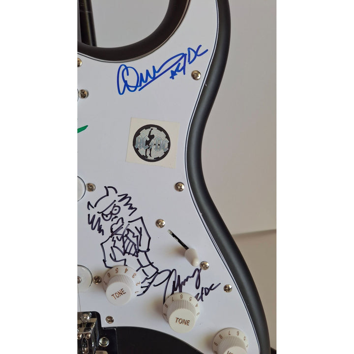 Angus & Malcolm Young, Brian Johnston, Phil Rudd, Cliff Williams AC/DC Fender Stratocaster electric guitar signed with proof
