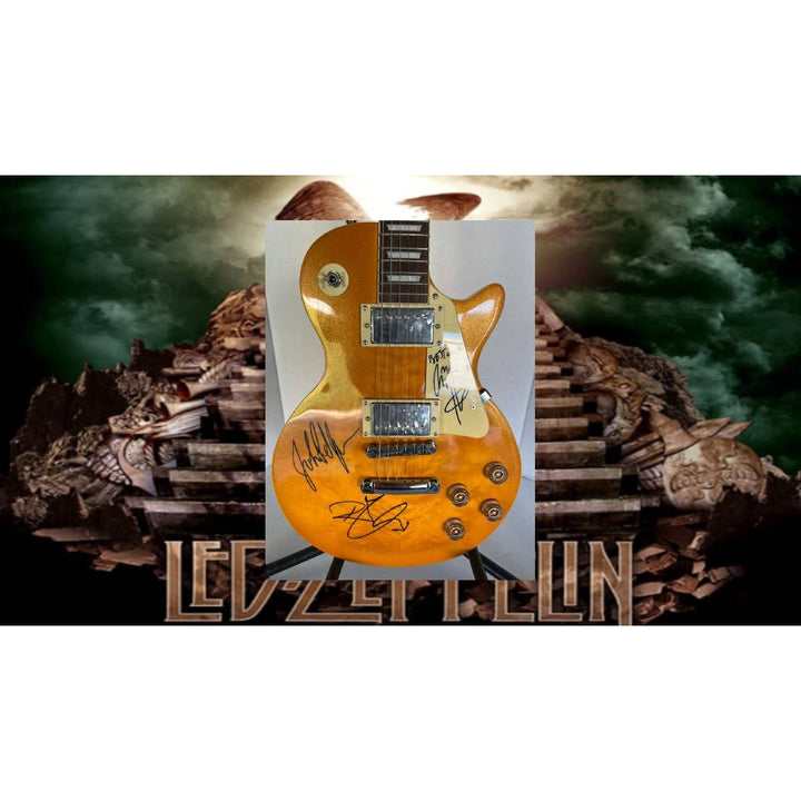 Led Zeppelin Jimmy Page, Robert Plant, John Paul Jones gold les paul electric guitar signed with proof.