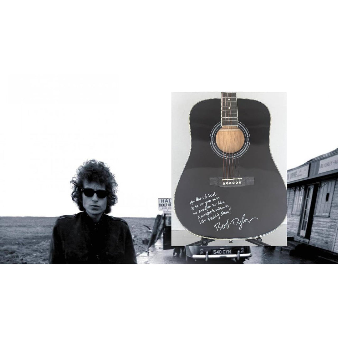 Bob Dylan black acoustic guitar signed with lyrics and signing proof.