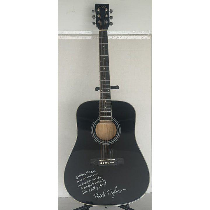 Bob Dylan black acoustic guitar signed with lyrics and signing proof.