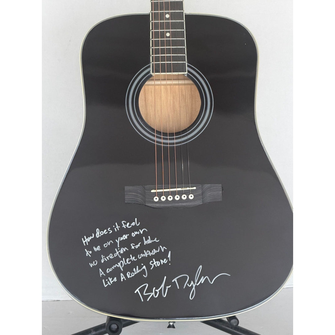 Bob Dylan black acoustic guitar signed with lyrics and signing proof.