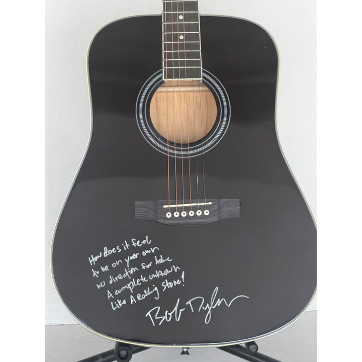 Bob Dylan black acoustic guitar signed with lyrics and signing proof.