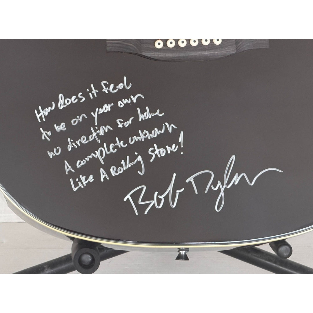 Bob Dylan black acoustic guitar signed with lyrics and signing proof.