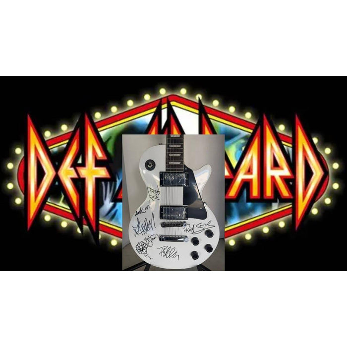 Def Leppard Phil Collen, Vivian Campbell, Joe Elliott, Rick Savage, Rick Allen. White Les Paul electric guitar signed with proof.