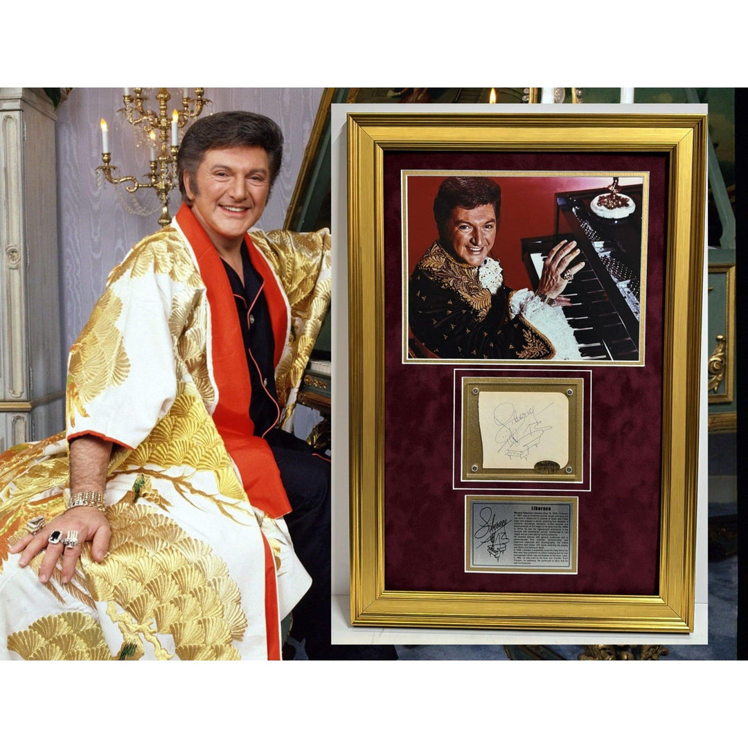 Person in gold robe sitting beside framed photo and memorabilia, with chandelier in the background.