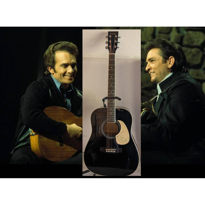 Two men in dark suits, each holding a guitar, with a black acoustic guitar in the center.