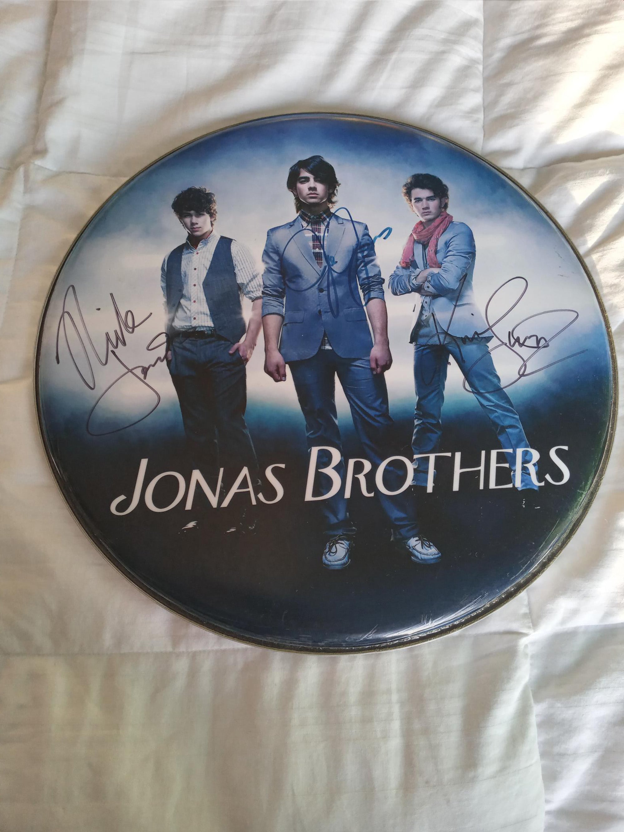 The Jonas Brothers 14 inch drum head signed with proof