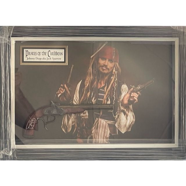 Johnny Depp Pirates of the Caribbean Jack Sparrow original flintlock Pirate pistol signed and framed (27x19x3.5) with proof